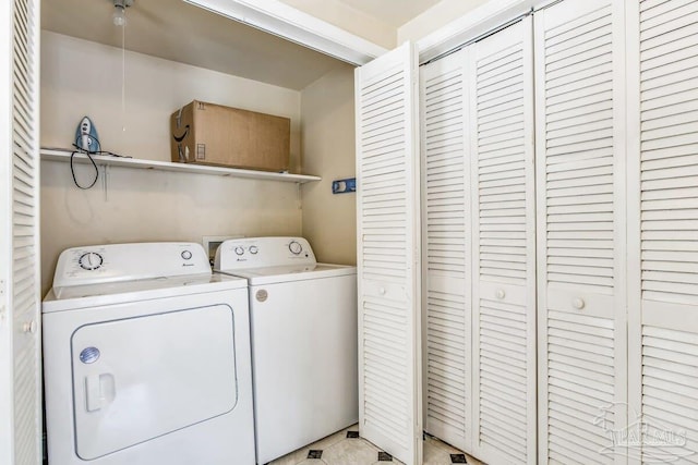 washroom featuring light tile patterned flooring and separate washer and dryer