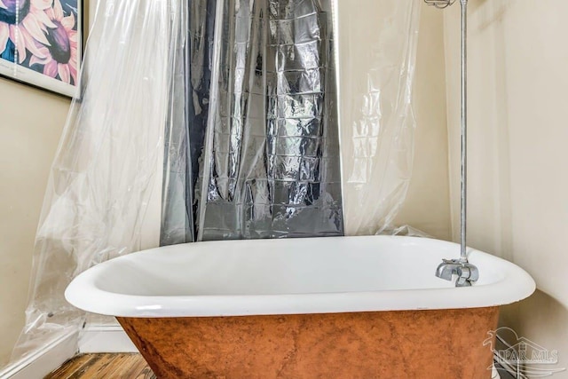 bathroom featuring a bath and wood-type flooring