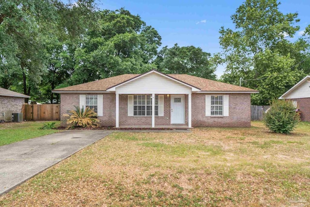 single story home featuring central air condition unit, a porch, a front lawn, and brick siding