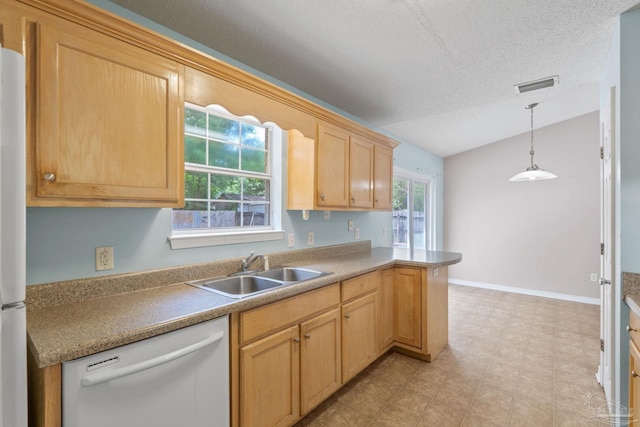 kitchen featuring visible vents, light brown cabinets, white appliances, a sink, and vaulted ceiling