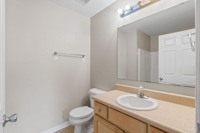 full bath with vanity, baseboards, walk in shower, and toilet