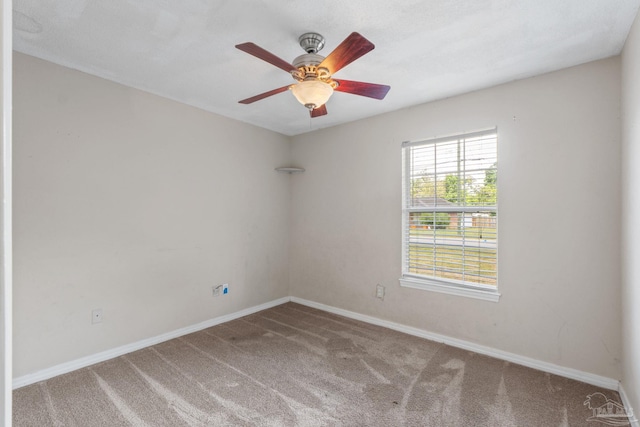 unfurnished room featuring carpet floors, baseboards, and ceiling fan