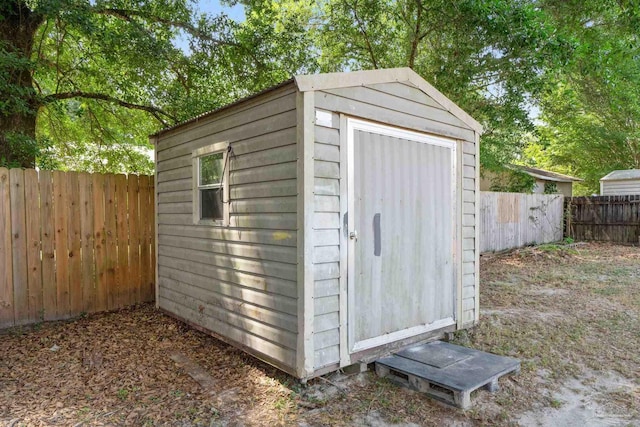 view of shed with a fenced backyard