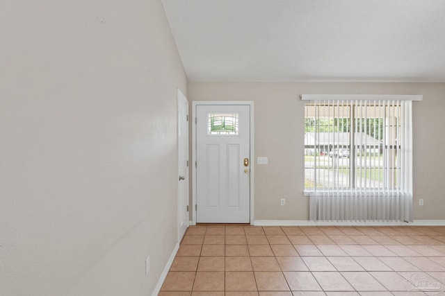 interior space with light tile patterned floors and baseboards