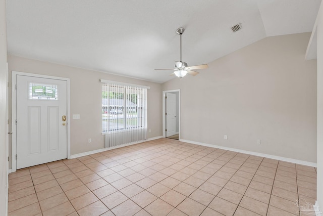 foyer entrance featuring a ceiling fan, vaulted ceiling, light tile patterned floors, and visible vents