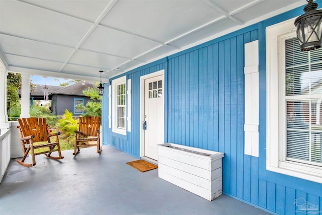 view of exterior entry with covered porch