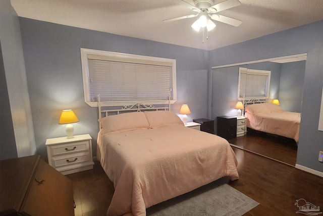 bedroom featuring a closet, wood finished floors, a ceiling fan, and baseboards