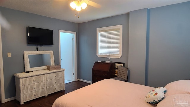 bedroom with baseboards and dark wood finished floors