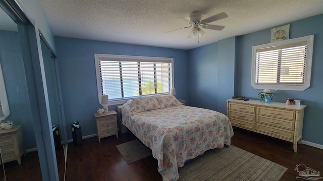 bedroom featuring a textured ceiling, baseboards, and dark wood-style flooring