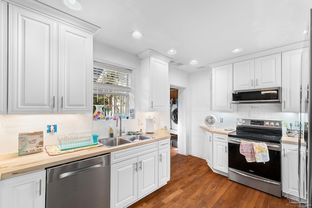 kitchen featuring sink, appliances with stainless steel finishes, white cabinetry, butcher block countertops, and dark wood-type flooring