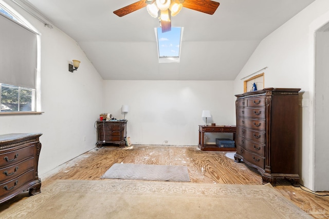 bedroom featuring lofted ceiling with skylight and ceiling fan