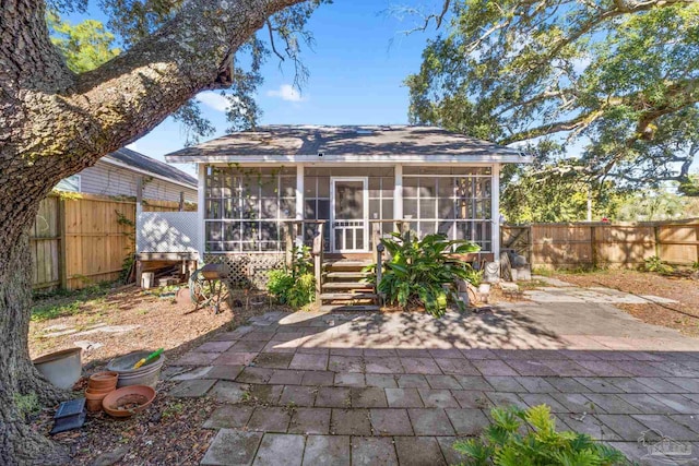 back of house with a patio and a sunroom