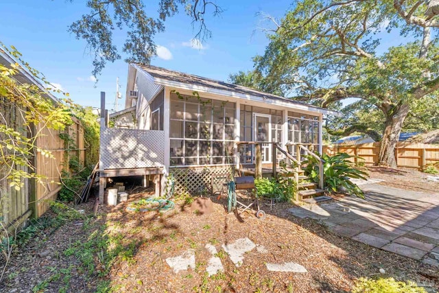 back of house with a sunroom