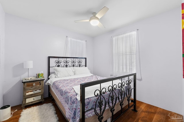 bedroom featuring ceiling fan and dark hardwood / wood-style floors