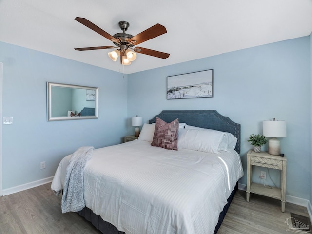 bedroom with hardwood / wood-style flooring and ceiling fan