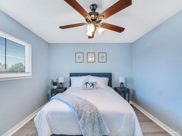 bedroom featuring hardwood / wood-style floors and ceiling fan