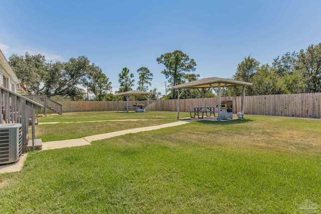 view of yard featuring a gazebo and central air condition unit