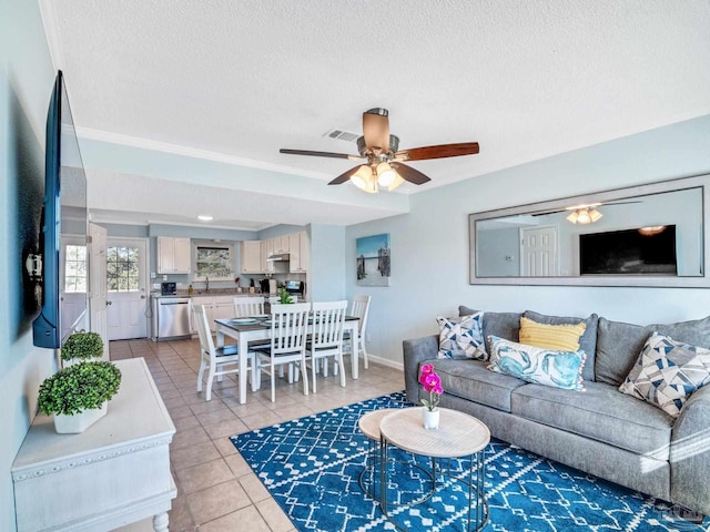 tiled living room with ceiling fan and a textured ceiling