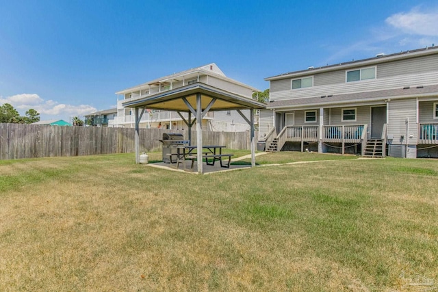 view of yard with a wooden deck and a patio area