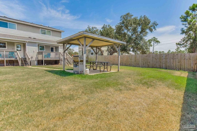 view of yard featuring a wooden deck and a patio