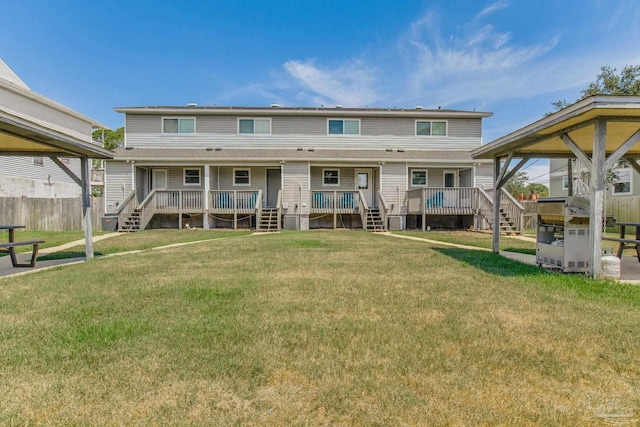 back of property featuring a yard and a deck