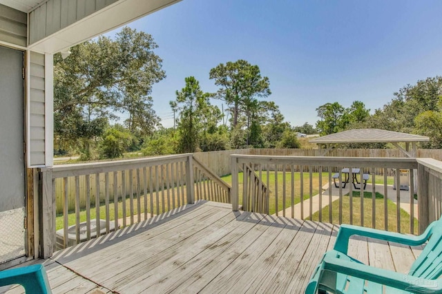 wooden deck with a lawn