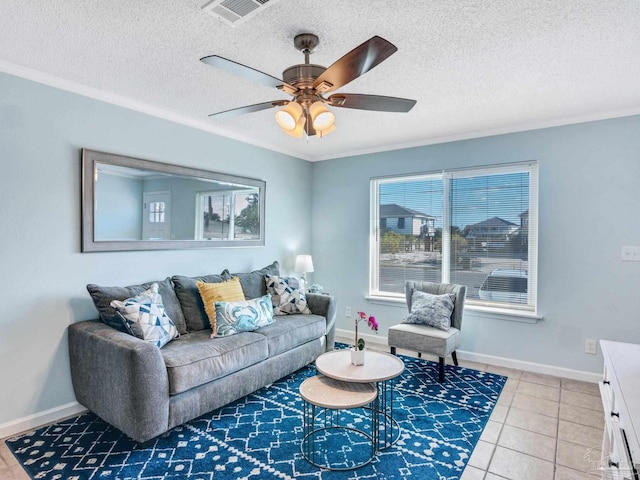 living room with ceiling fan, crown molding, tile patterned floors, and a textured ceiling