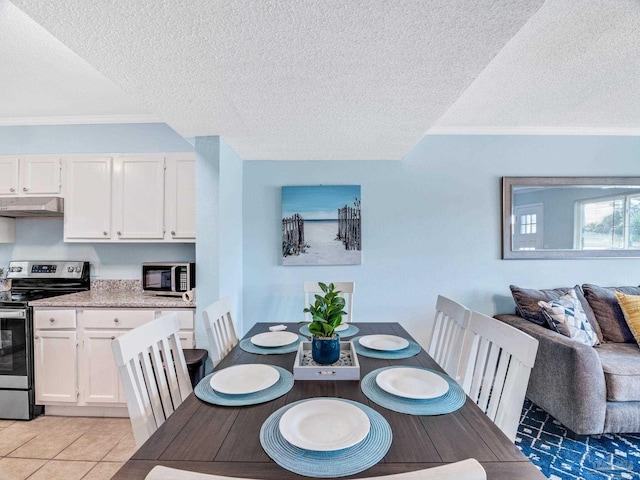 dining area featuring crown molding, light tile patterned floors, and a textured ceiling