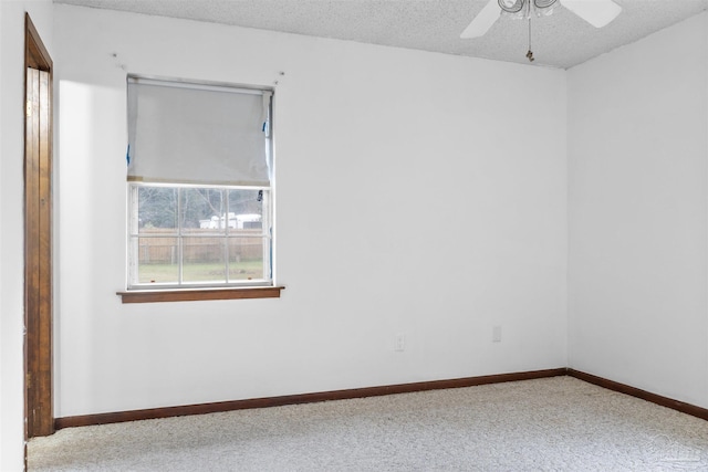 unfurnished room with ceiling fan, carpet floors, and a textured ceiling