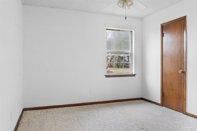 unfurnished room featuring ceiling fan, carpet flooring, and a textured ceiling