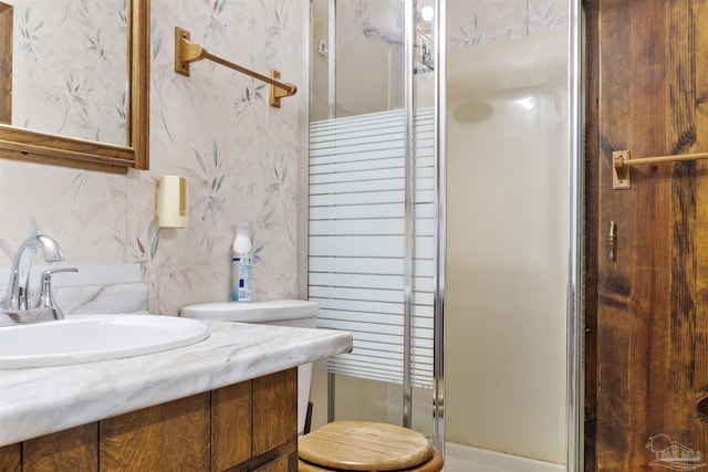 bathroom with walk in shower and vanity