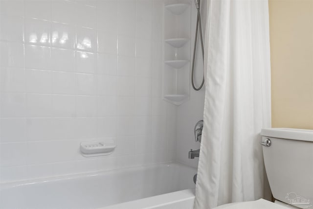 bathroom featuring shower / bathtub combination with curtain and toilet