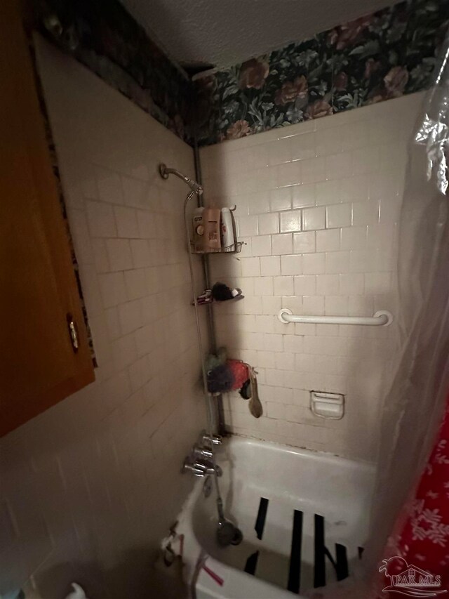 bathroom with shower / bath combo with shower curtain