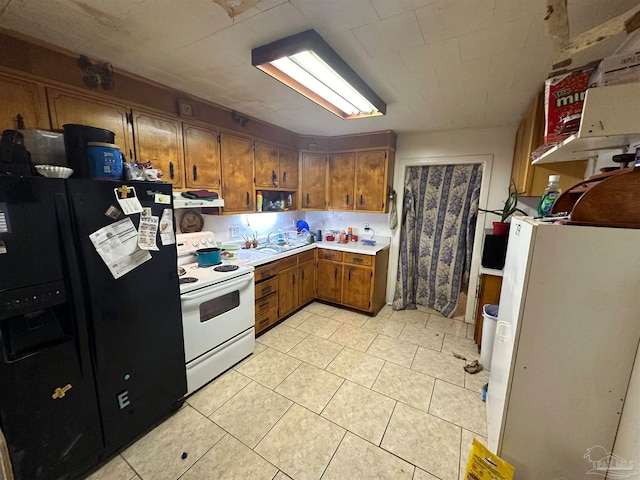 kitchen featuring light tile patterned floors, white appliances, and extractor fan