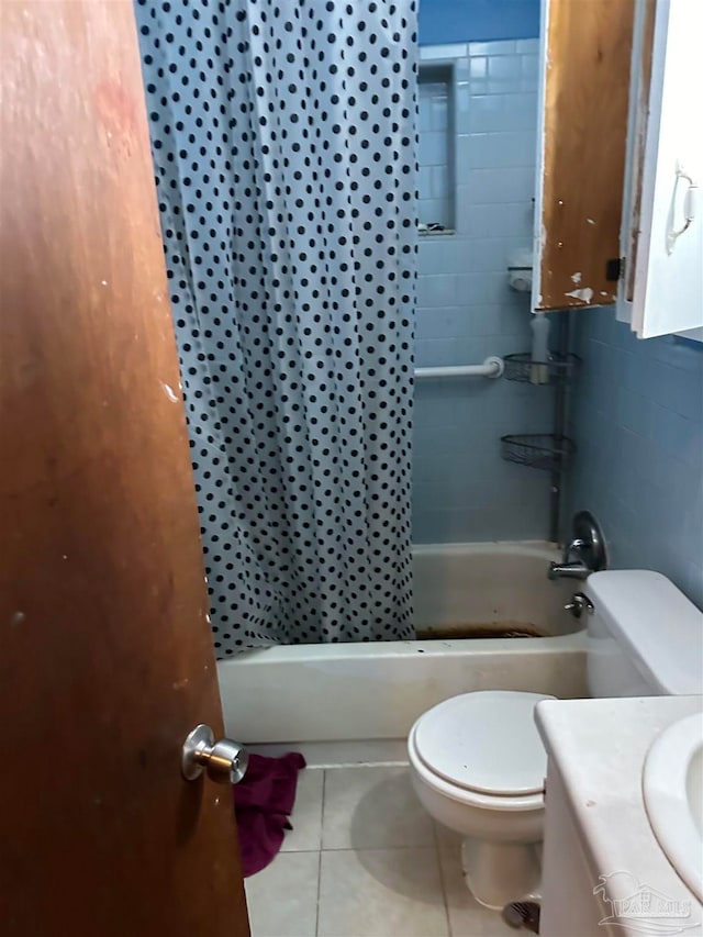 full bathroom with shower / bath combo with shower curtain, tile patterned floors, toilet, and vanity