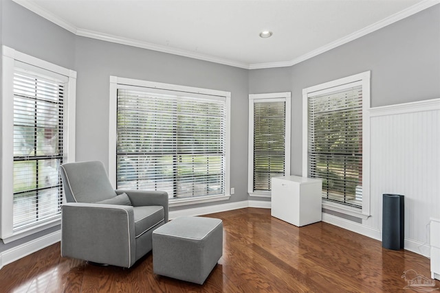 sitting room featuring baseboards, ornamental molding, and wood finished floors