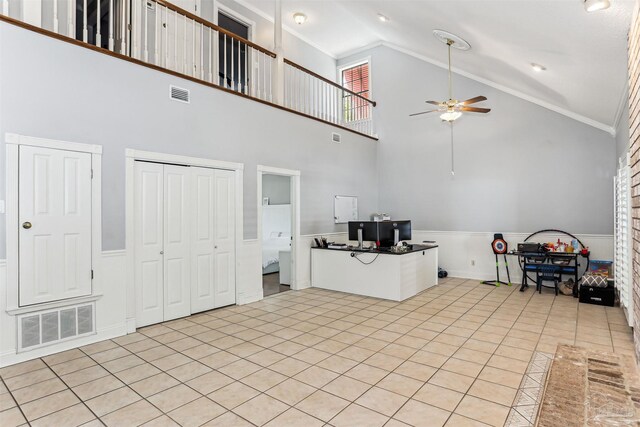 unfurnished living room with a ceiling fan, visible vents, and ornamental molding