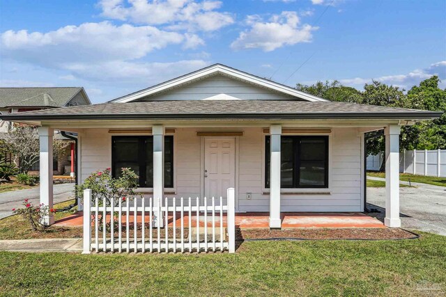 bungalow-style house featuring a porch, fence, and a shingled roof