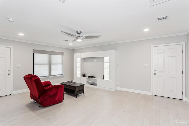 living room with ceiling fan, visible vents, baseboards, ornamental molding, and light wood-style flooring