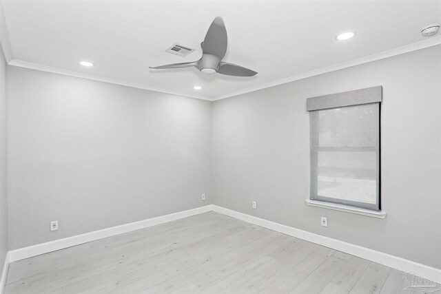 spare room with visible vents, ornamental molding, ceiling fan, and wood finished floors