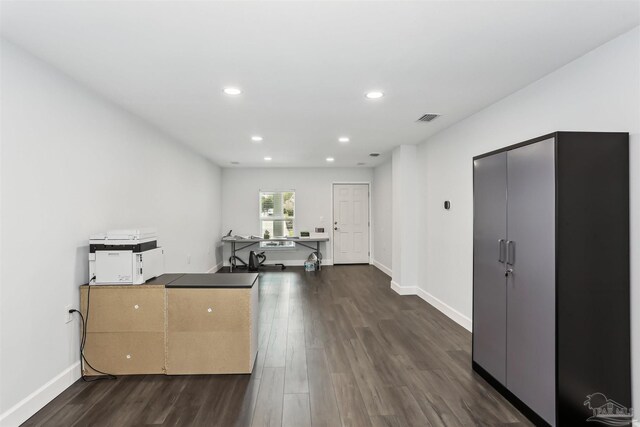 interior space featuring recessed lighting, baseboards, visible vents, and dark wood-style floors