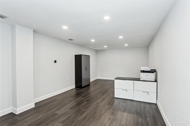 basement with recessed lighting, baseboards, and dark wood-style flooring