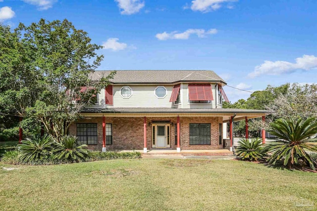 farmhouse featuring brick siding, a front lawn, and covered porch