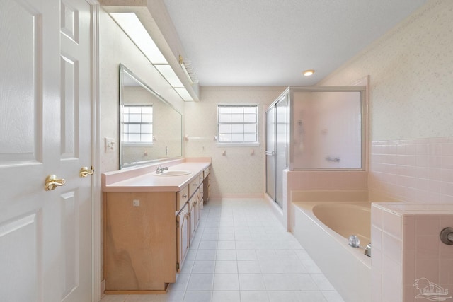 bathroom featuring tile patterned floors, vanity, separate shower and tub, and a textured ceiling