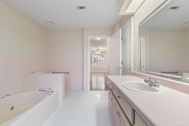 bathroom featuring tile patterned floors, vanity, ceiling fan, and a bath