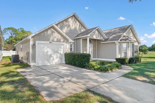 view of front of property featuring cooling unit, a garage, and a front yard