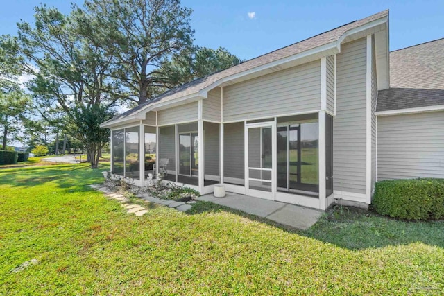 1180 Lionsgate Ln, Gulf Breeze, FL 32563 - view of side of property with a sunroom, a shingled roof, and a lawn