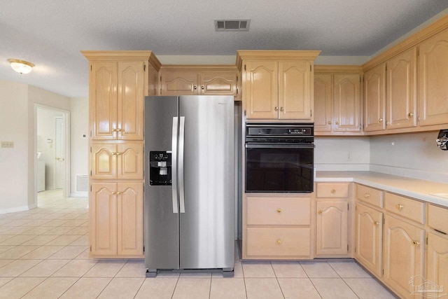 kitchen with stainless steel fridge with ice dispenser, light tile patterned floors, a textured ceiling, and oven