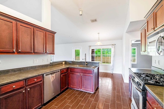 11532 Aruba Dr, Pensacola, FL 32506 - kitchen featuring dark countertops, baseboards, reddish brown cabinets, a sink, and stainless steel appliances