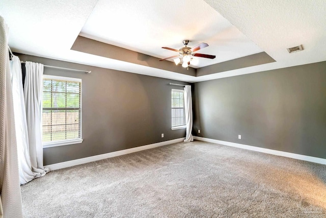 11532 Aruba Dr, Pensacola, FL 32506 - carpeted empty room with a tray ceiling, visible vents, a healthy amount of sunlight, and baseboards
